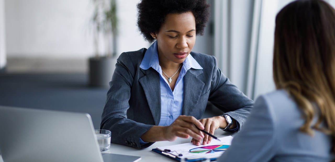 A client and her financial advisor reviewing potential methods to rebalance her portfolio 